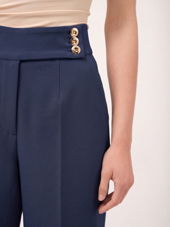 Trousers with buttoned strap