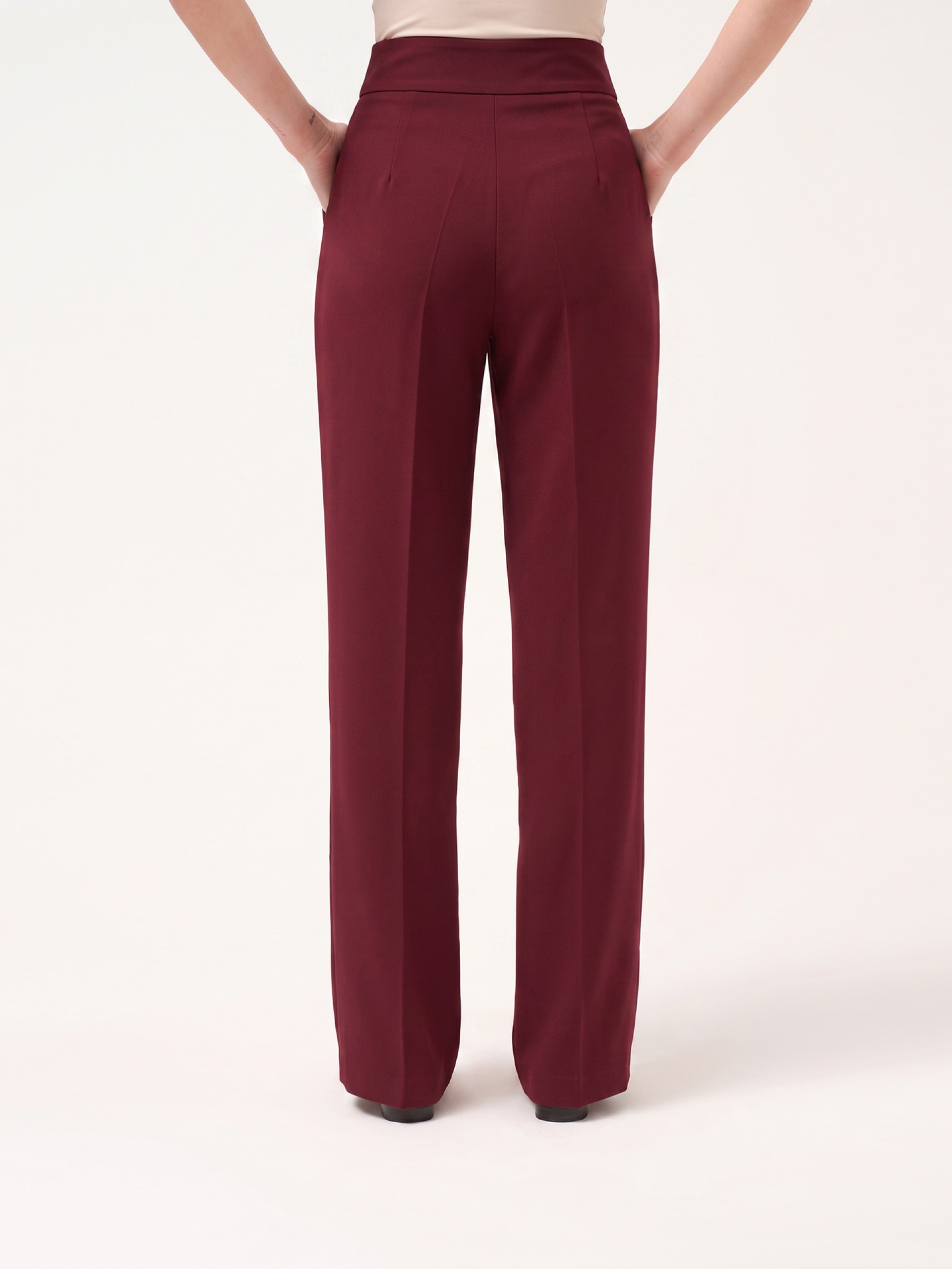 Trousers with buttoned strap