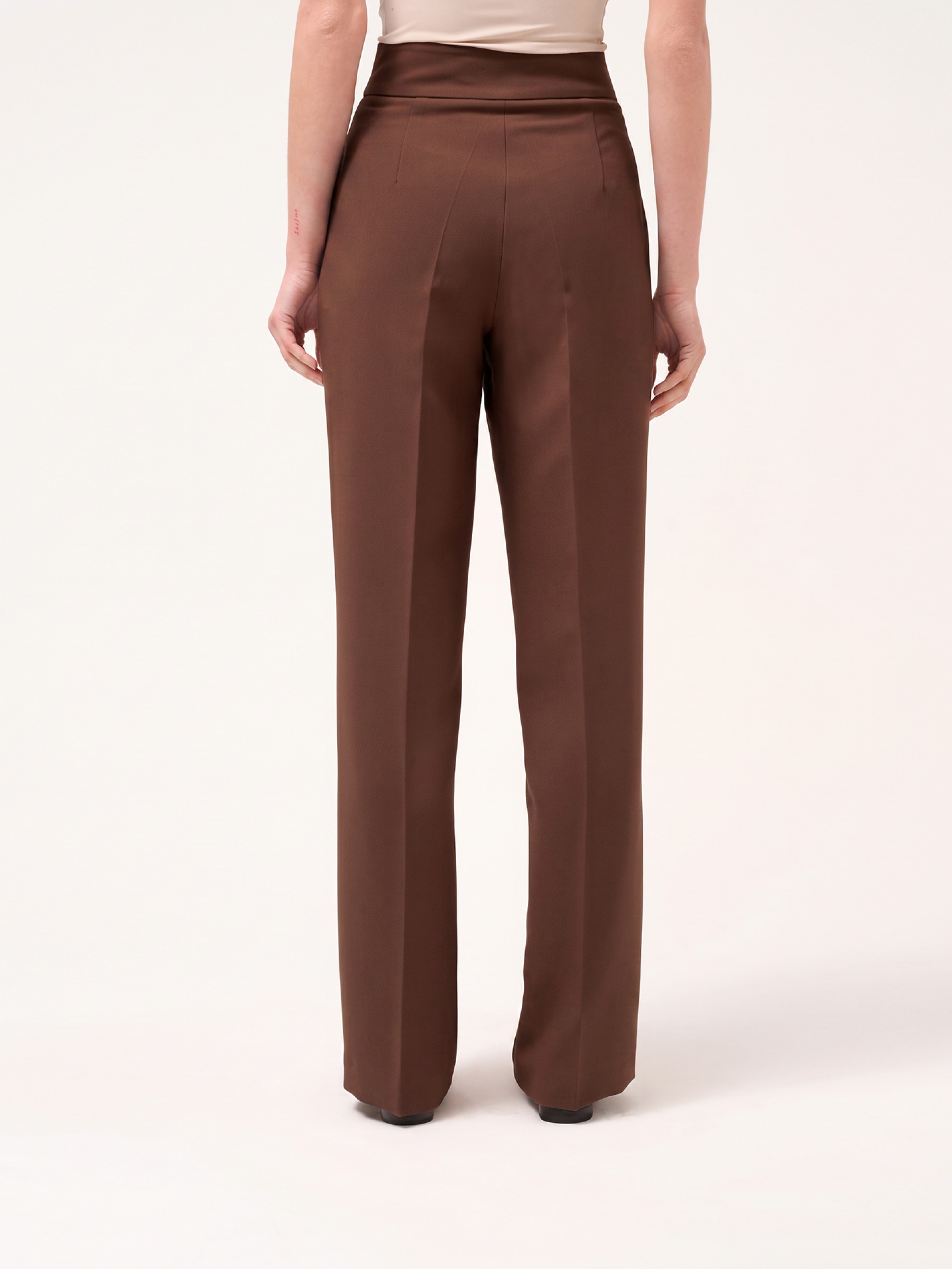 Trousers with buttoned strap